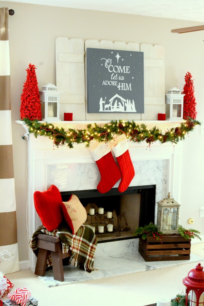 Red and festive Christmas mantel with DIY lit canvas