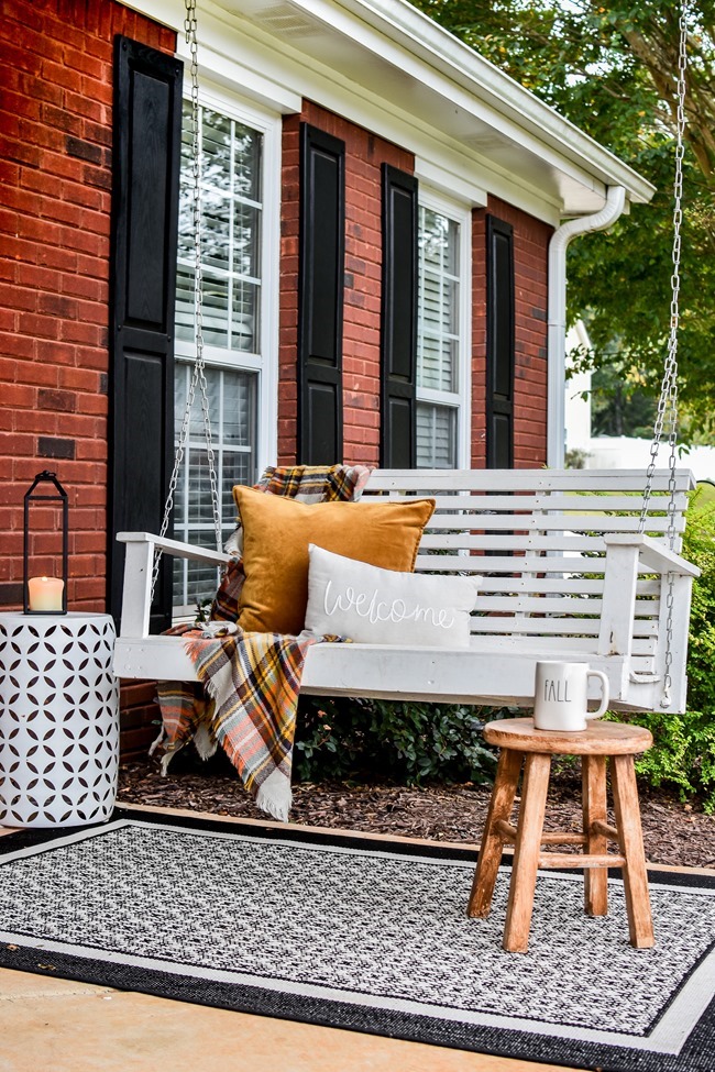 Farmhouse fall front porch with lots of mums, hay and pumpkins-10