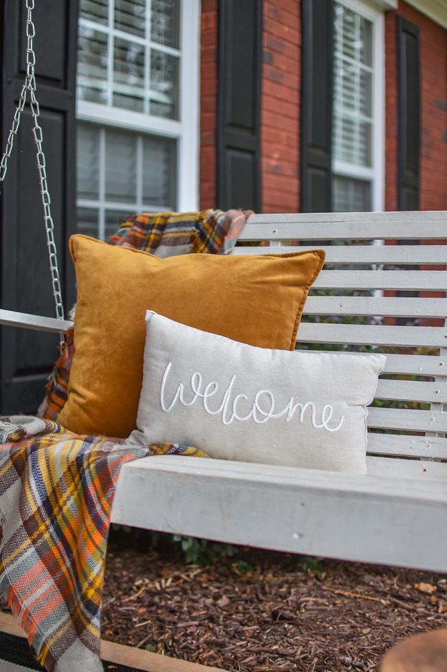 Farmhouse fall front porch with lots of mums, hay and pumpkins-12