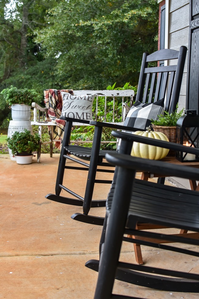 Farmhouse fall front porch with lots of mums, hay and pumpkins-7