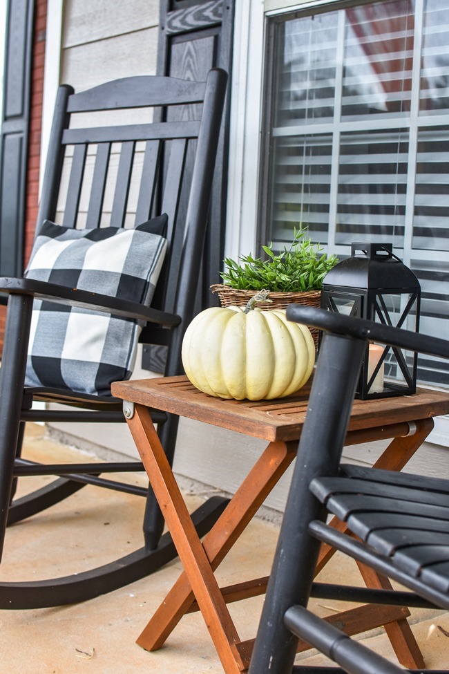 Farmhouse fall front porch with lots of mums, hay and pumpkins-8