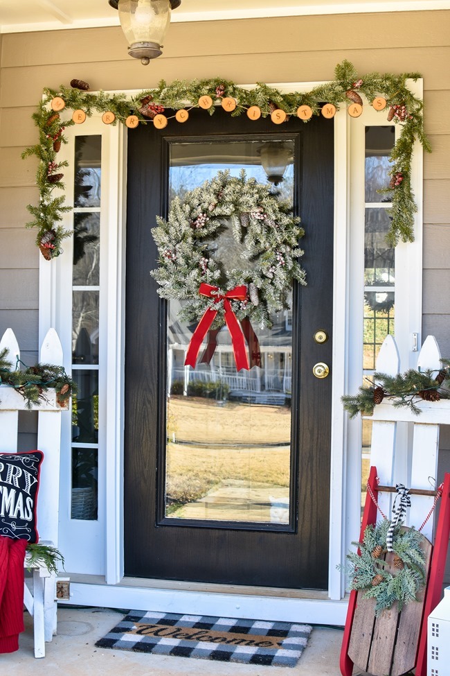 Farmhouse style Christmas front porch with picket fences-18