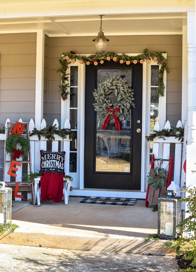 Farmhouse style Christmas front porch with picket fences-19