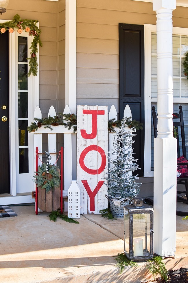 Farmhouse style Christmas front porch with picket fences-25